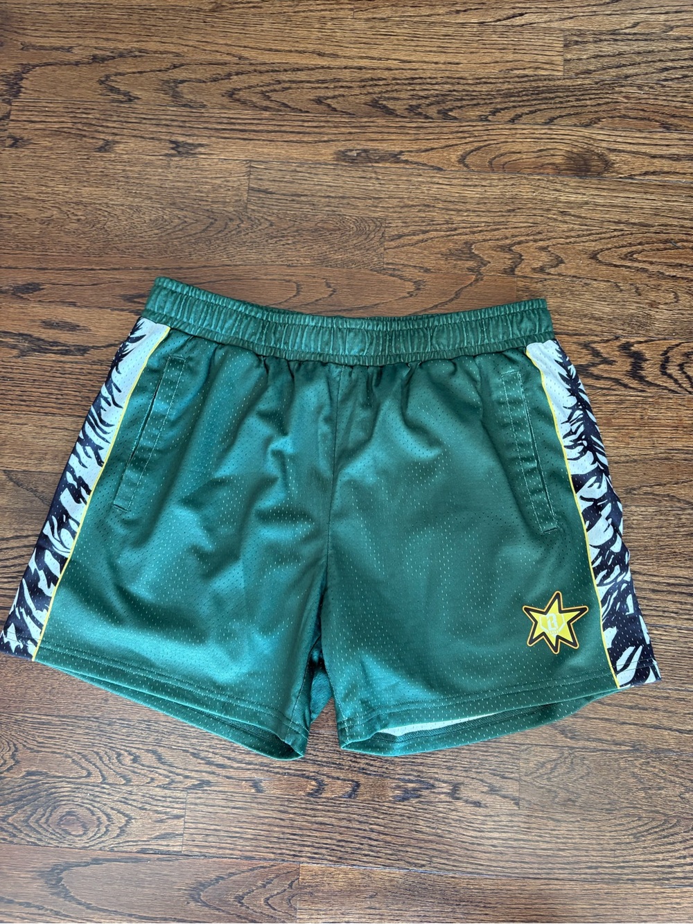 Green Athletic Shorts with Zebra Side Panels and Yellow Star Accent